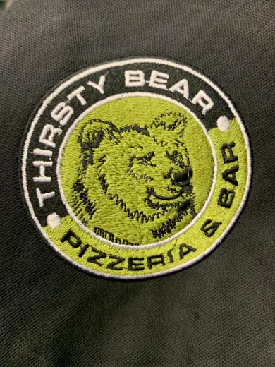 Embroidered polo shirts in a team colour